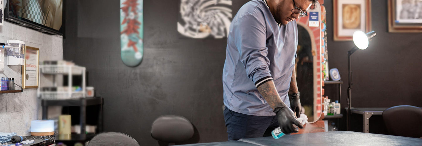 Tattoo artist cleaning the tattoo studio